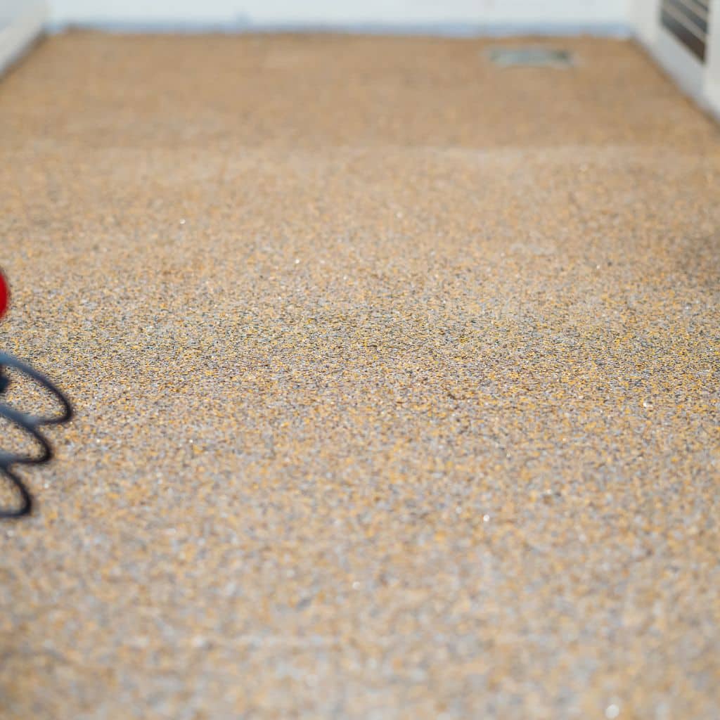 Yellowing epoxy flooring with visible fading and discoloration.